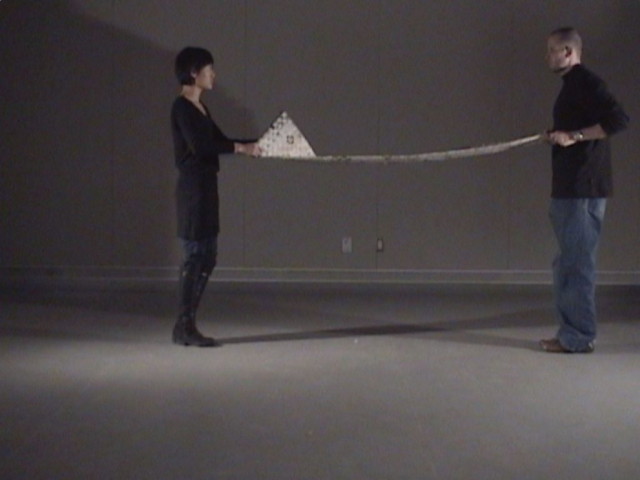 Finational [Canadian Flag] (2008) (performance still) by Annie Onyi Cheung